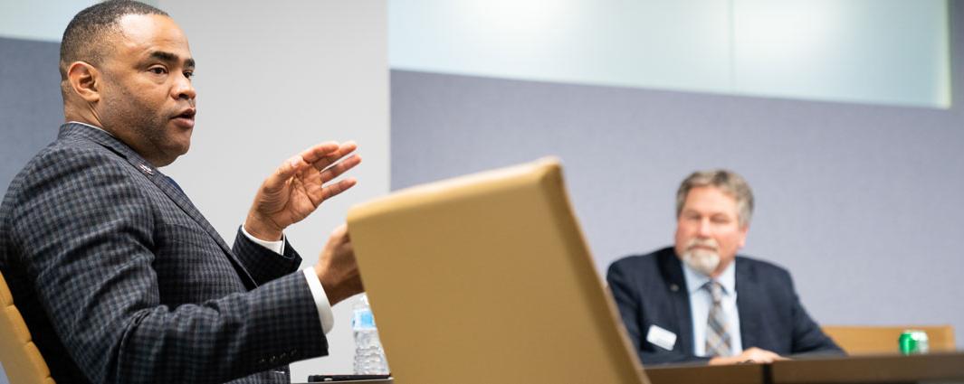 two men in suits at table